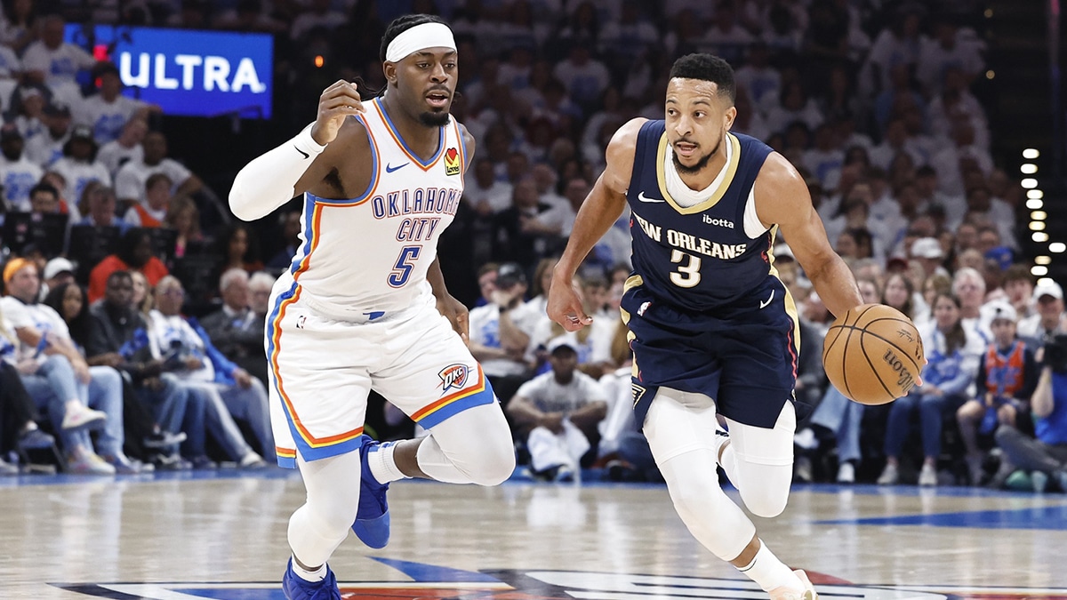  New Orleans Pelicans guard CJ McCollum (3) drives to the basket around Oklahoma City Thunder guard Luguentz Dort (5) during the second quarter of game one of the first round for the 2024 NBA playoffs at Paycom Center.