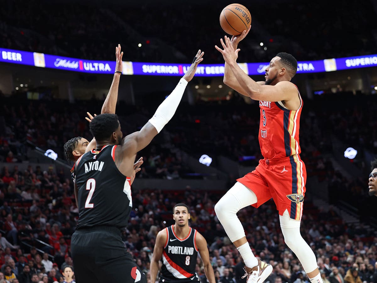 New Orleans Pelicans guard CJ McCollum (3) shoots the ball over Portland Trail Blazers center Deandre Ayton (2) as Trail Blazers’ forward Kris Murray (8) watches in the second quarter at Moda Center.