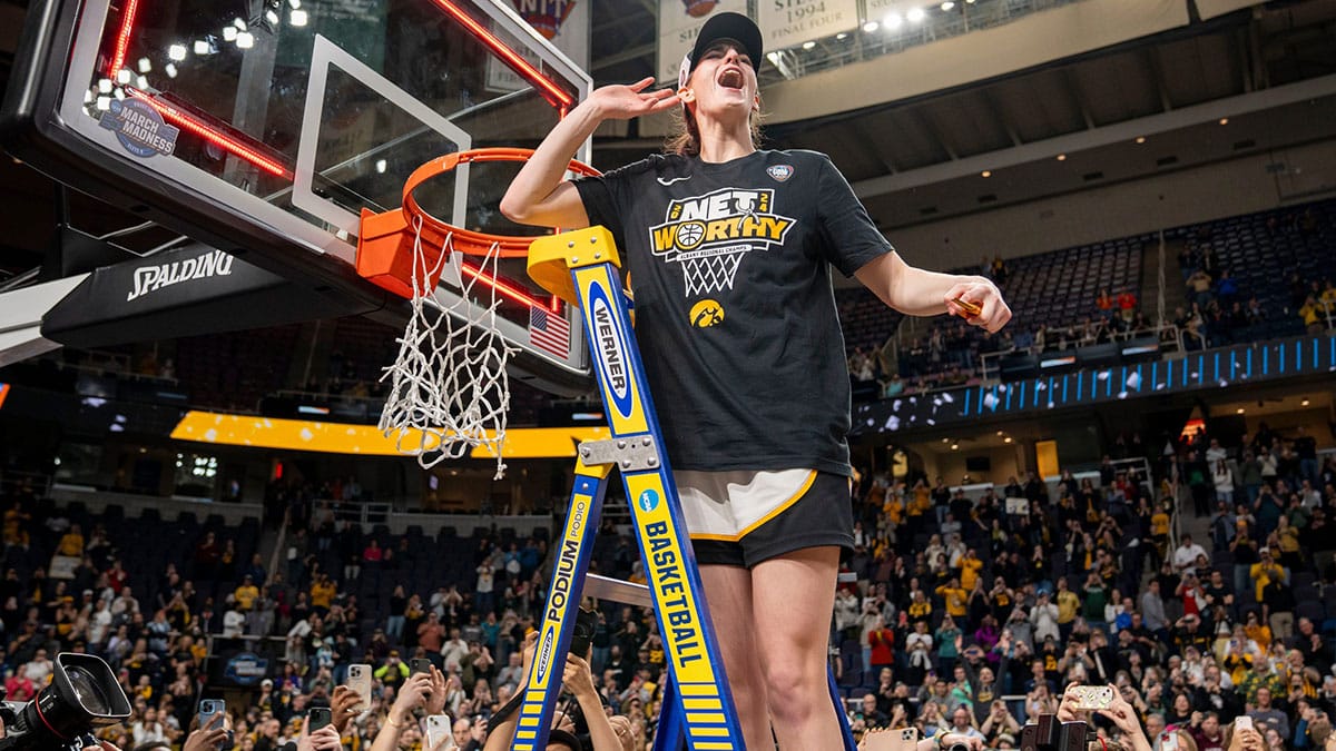 owa Hawkeyes guard Caitlin Clark (22) cuts down the net after beating LSU in the Elite 8 round of the NCAA Women's Basketball Tournament between Iowa and LSU