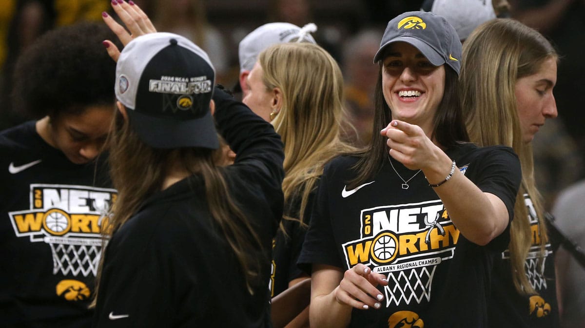 Iowa’s Caitlin Clark points to the crowd during a celebration of the Iowa women’s basketball team.