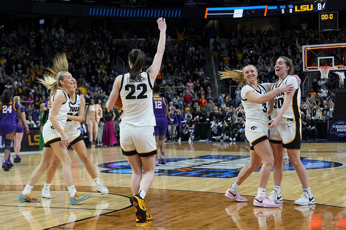 Iowa Hawkeyes guard Caitlin Clark (22) celebrates with teammates after defeating the LSU Lady Tigers in the finals of the Albany Regional in the 2024 NCAA Tournament at MVP Arena. 