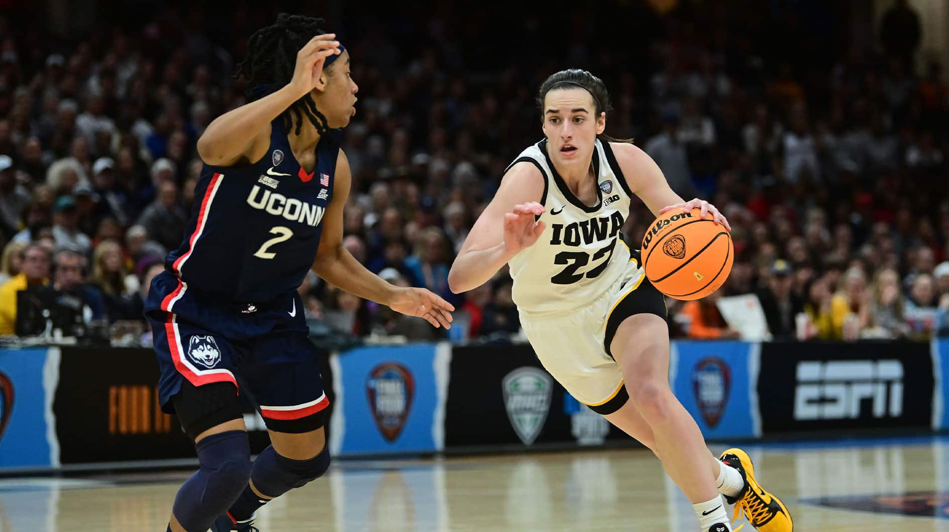 Iowa Hawkeyes guard Caitlin Clark (22) dribbles the ball against Connecticut Huskies guard KK Arnold (2) in the semifinals of the Final Four of the womens 2024 NCAA Tournament at Rocket Mortgage FieldHouse