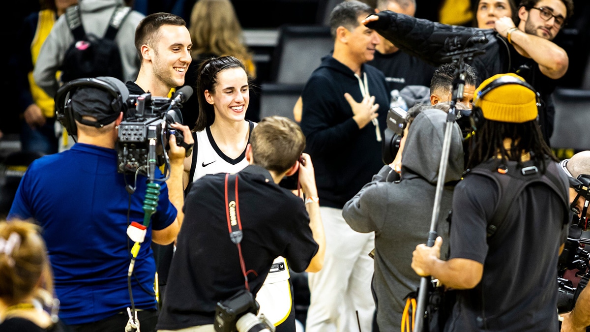 Iowa guard Caitlin Clark poses for a photo with Connor McCaffery after a NCAA Big Ten Conference women's basketball game against Michigan.