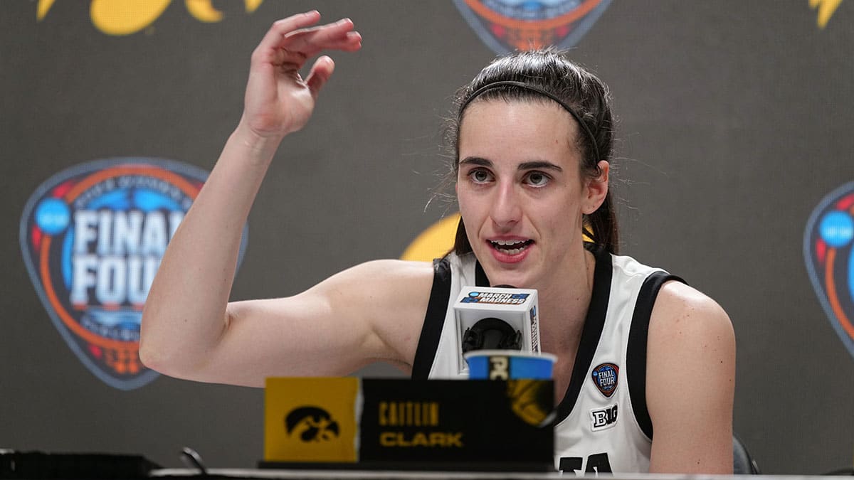 Iowa Hawkeyes guard Caitlin Clark (22) takes questions after winning the Final Four round of the NCAA Women's Basketball Tournament