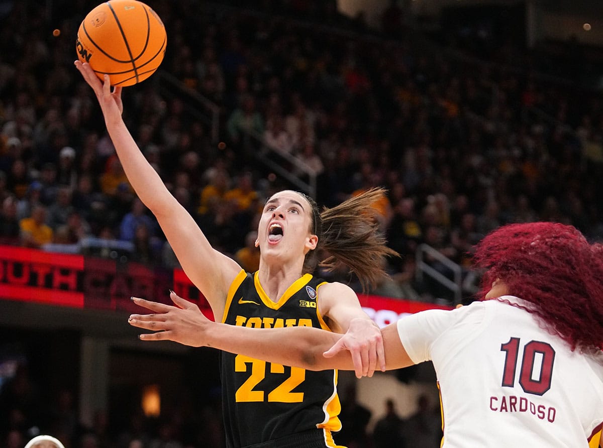 WNBA Draft prospect Caitlin Clark shooting over Kamilla Cardoso during the March Madness National Championship Game