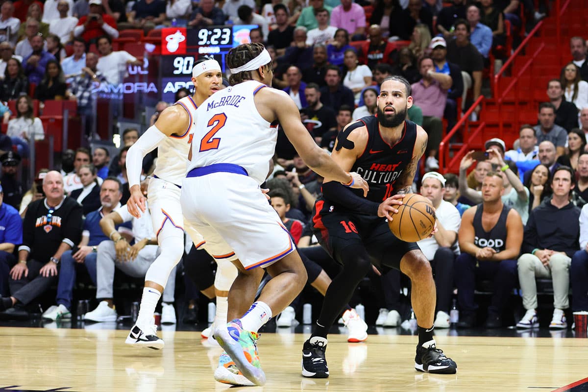 Miami Heat forward Caleb Martin (16) drives to the basket against New York Knicks guard Miles McBride (2) during the fourth quarter at Kaseya Center.