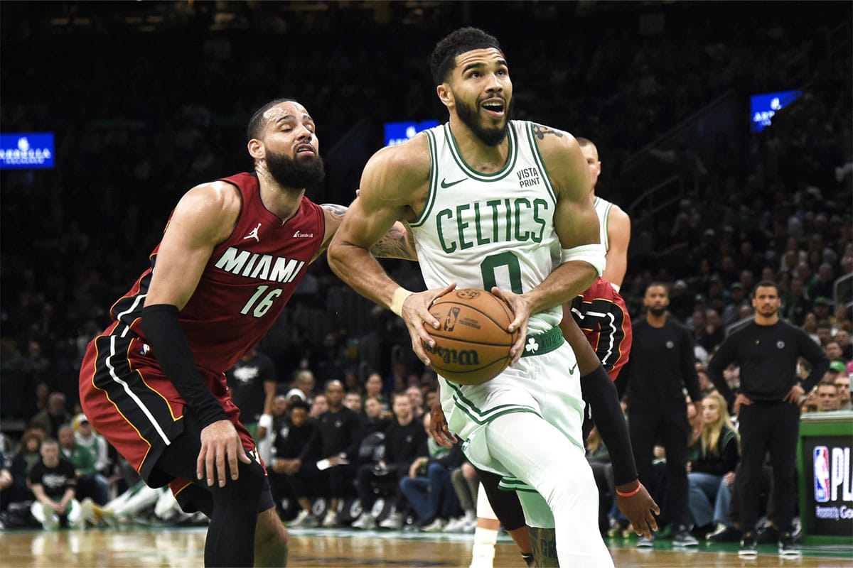 Boston Celtics forward Jayson Tatum (0) drives to the basket past Miami Heat forward Caleb Martin (16) during the second half in game one of the first round for the 2024 NBA playoffs at TD Garden.