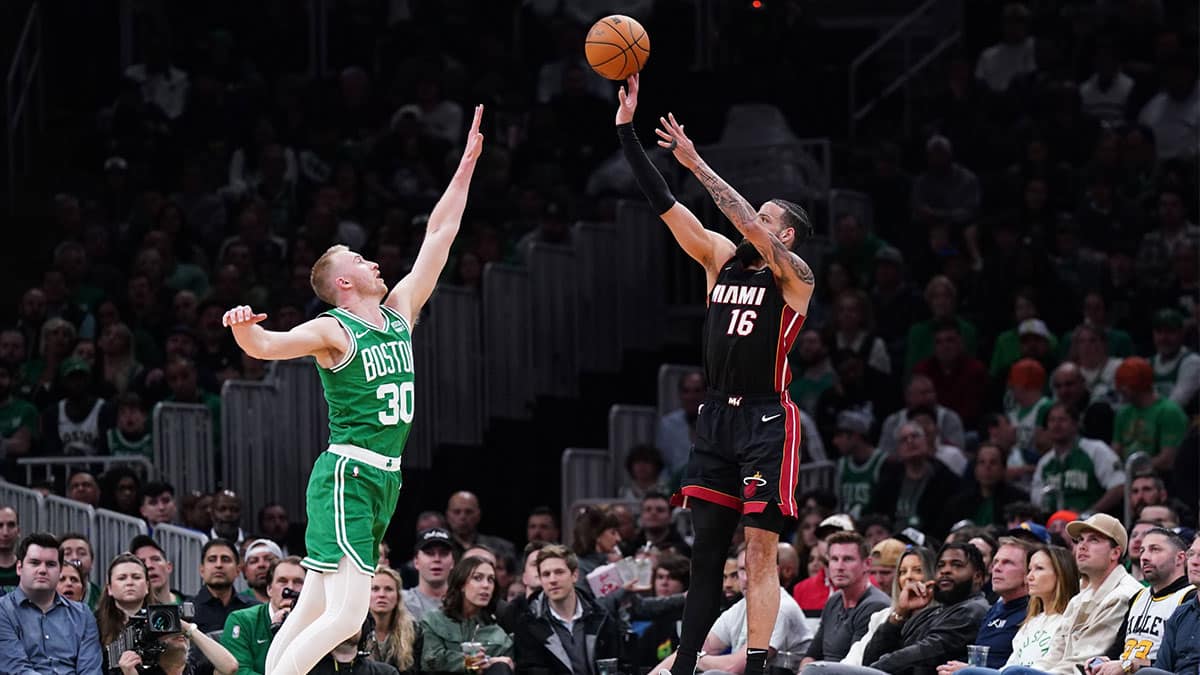 Miami Heat forward Caleb Martin (16) shoots for three points against Boston Celtics forward Sam Hauser (30) in the second quarter during game two of the first round for the 2024 NBA playoffs at TD Garden. 