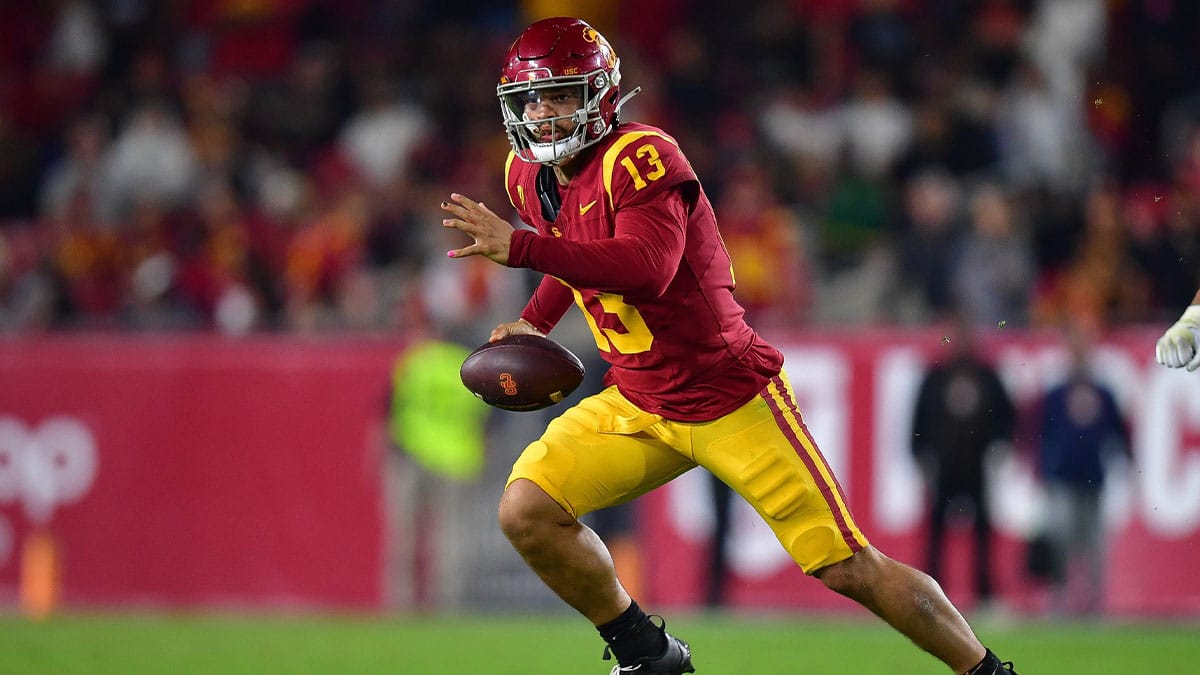 Trojans quarterback Caleb Williams (13) runs the ball during the second overtime against the Arizona Wildcats at Los Angeles Memorial Coliseum