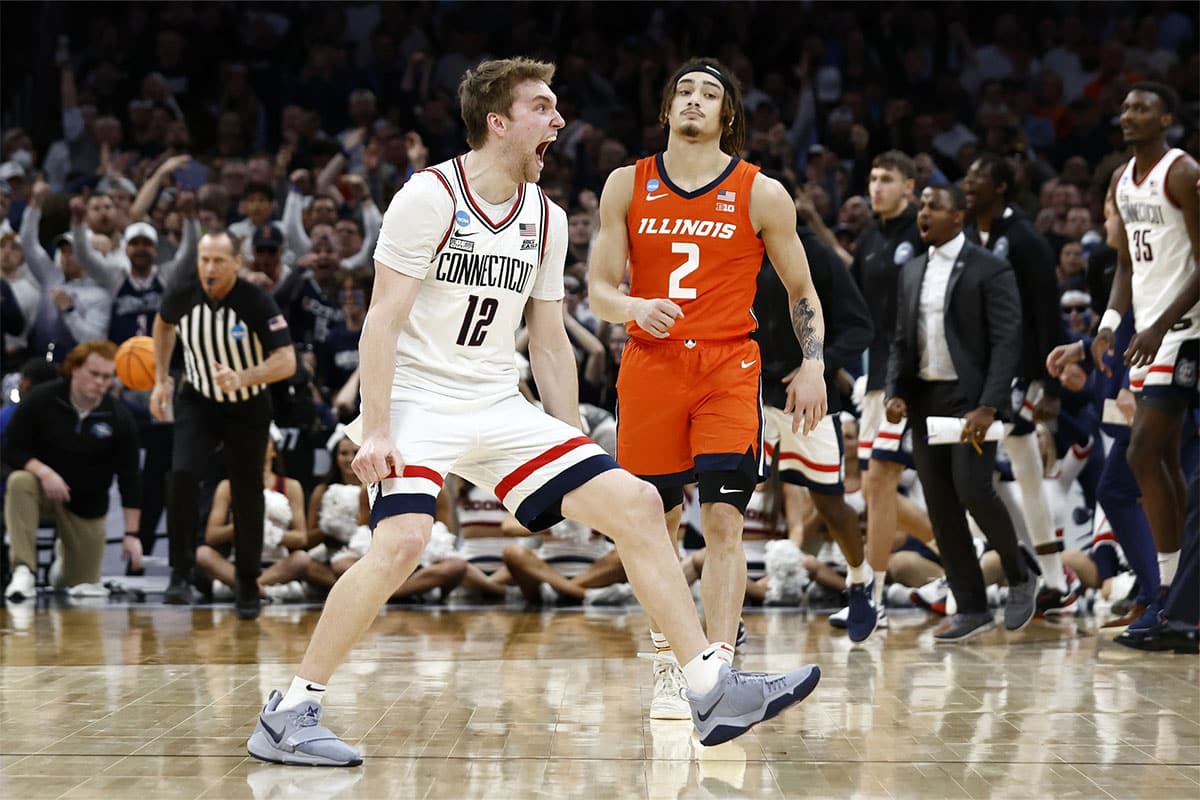 Connecticut Huskies guard Cam Spencer (12) reacts against the Illinois Fighting Illini in the finals of the East Regional of the 2024 NCAA Tournament at TD Garden.