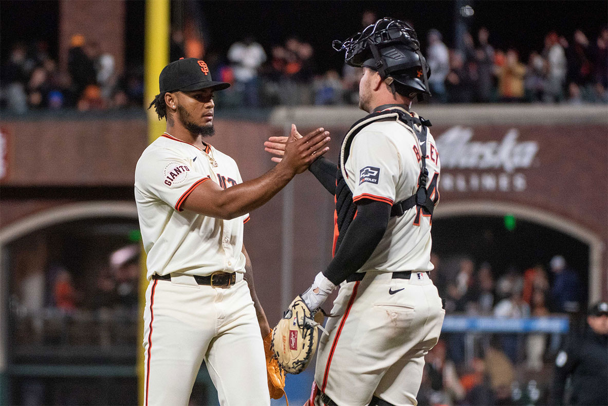 San Francisco Giants pitcher Camilo Doval (75) and catcher Patrick Bailey (14) celebrate after defeating the New York Mets at Oracle Park.