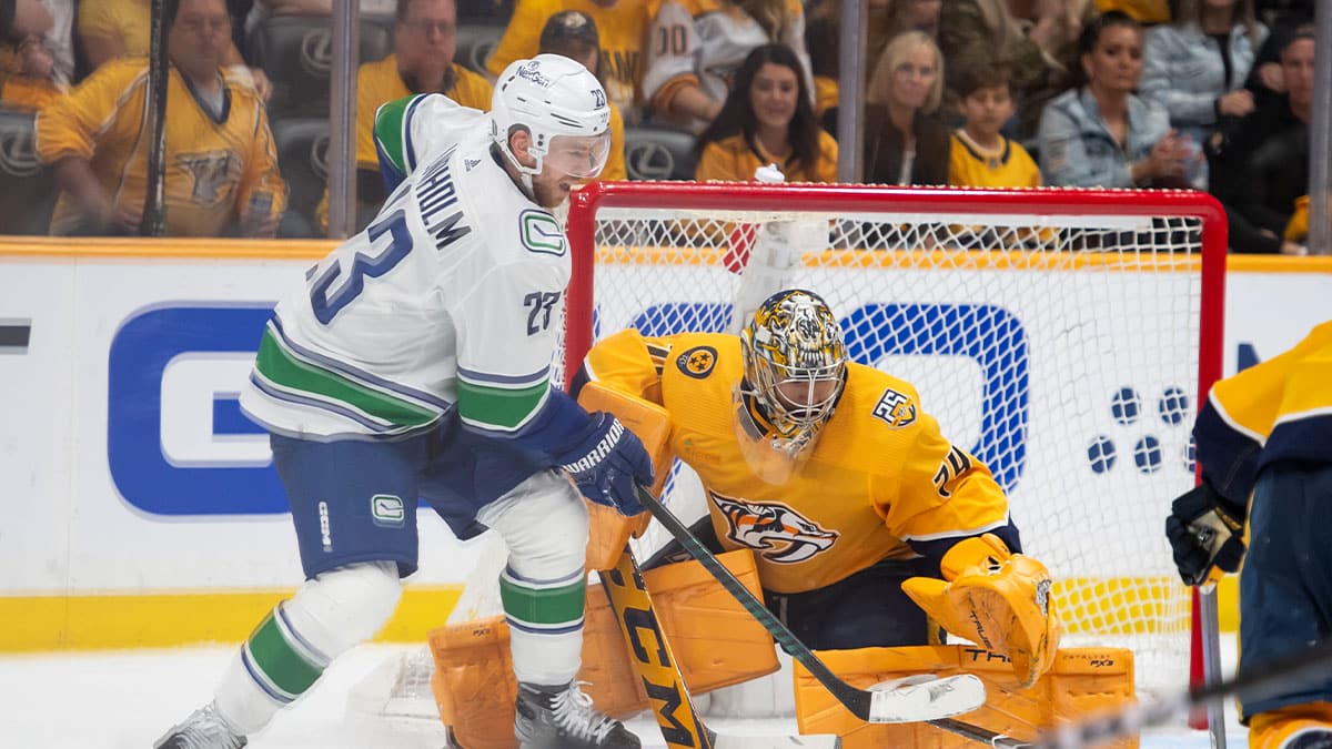 Nashville Predators goaltender Juuse Saros (74) blocks the shot ion Vancouver Canucks center Elias Lindholm (23) during the third period in game four of the first round of the 2024 Stanley Cup Playoffs at Bridgestone Arena.