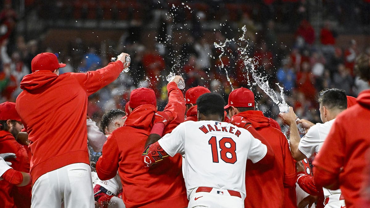 St. Louis Cardinals second baseman Nolan Gorman (16) is mobbed at home plate by teammates after hitting a walk-off two run home run against the Arizona Diamondbacks during the ninth inning at Busch Stadium.