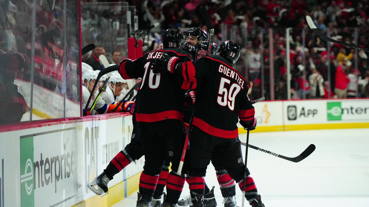 Carolina Hurricanes center Sebastian Aho (20) celebrates his goal with defenseman Brady Skjei (76), center Jake Guentzel (59) and defenseman Brent Burns (8) against the New York Islanders during the third period in game two of the first round of the 2024 Stanley Cup Playoffs at PNC Arena