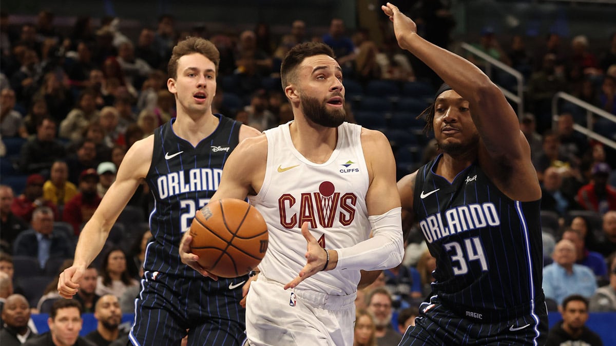 Cleveland Cavaliers guard Max Strus (1) drives to the basket as Orlando Magic center Wendell Carter Jr. (34) defends during the first quarter at Kia Center. 