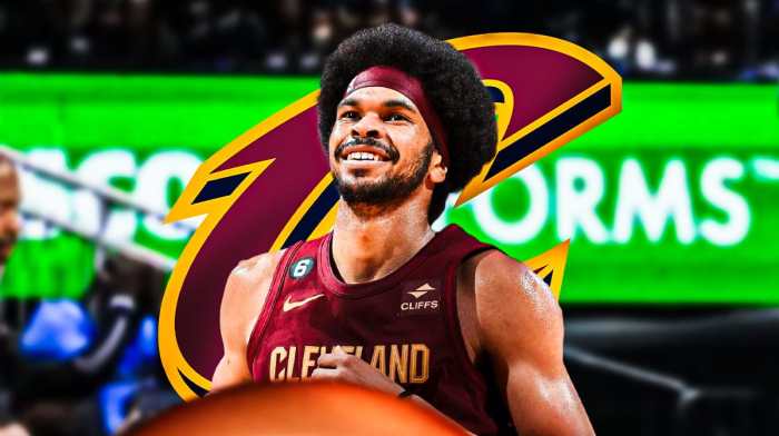 Jarrett Allen in image looking happy, Cleveland Cavaliers logo, basketball court in background