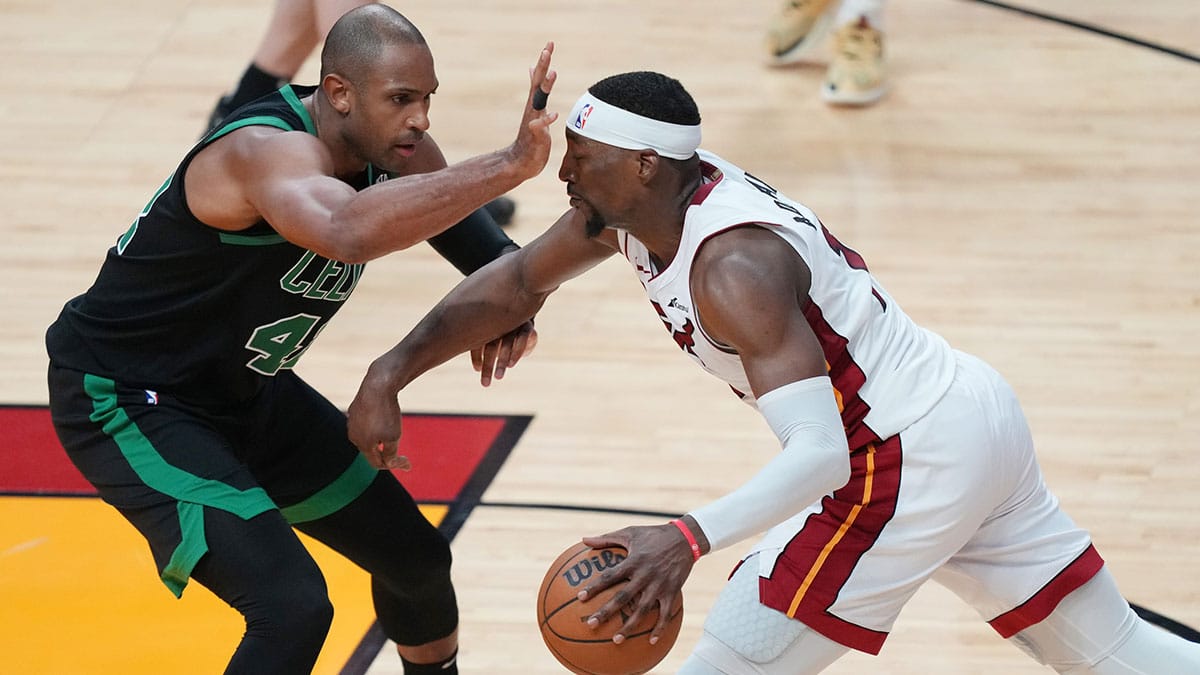 Miami Heat center Bam Adebayo (13) drives to the basket as Boston Celtics center Al Horford (42) defends in the second half during game three of the first round for the 2024 NBA playoffs at Kaseya Center.