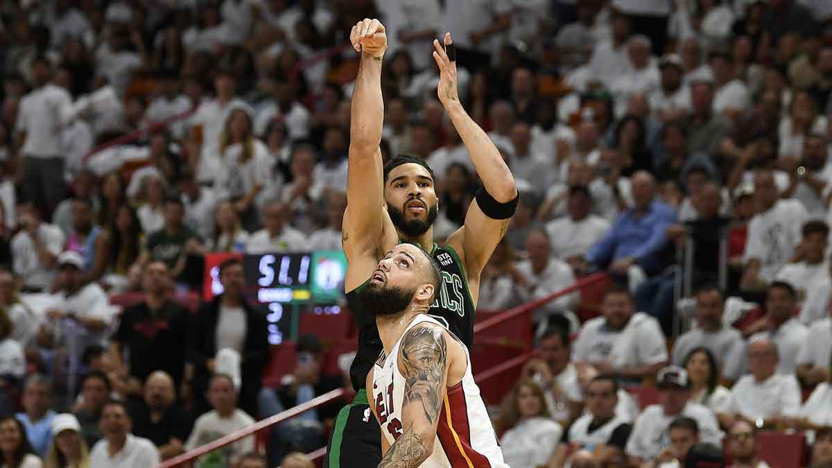 Boston Celtics forward Jayson Tatum (0) takes a 3-point shot in front of Miami Heat forward Caleb Martin (16) during the second quarter of game four of the first round for the 2024 NBA playoffs at Kaseya Center.