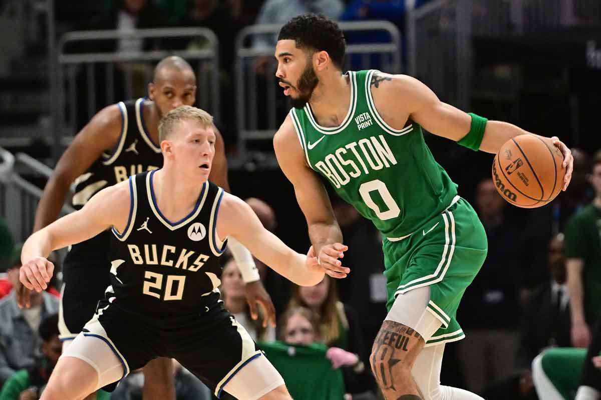 Boston Celtics forward Jayson Tatum (0) drives past Milwaukee Bucks guard AJ Green (20) in the second quarter at Fiserv Forum