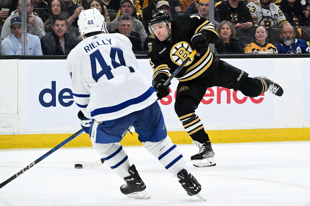 Boston Bruins center Charlie Coyle (13) takes a shot against Toronto Maple Leafs defenseman Morgan Rielly (44) during the third period in game two of the first round of the 2024 Stanley Cup Playoffs at TD Garden.