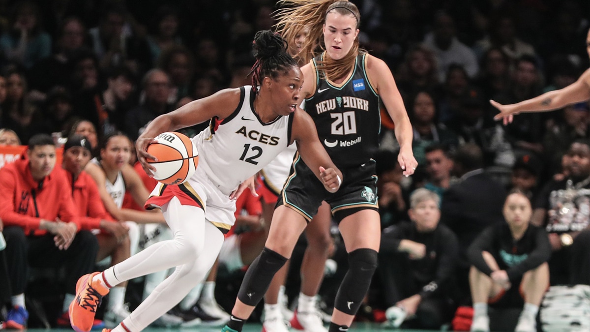 Las Vegas Aces guard Chelsea Gray (12) drives around New York Liberty guard Sabrina Ionescu (20) in the third quarter during game three of the 2023 WNBA Finals at Barclays Center.