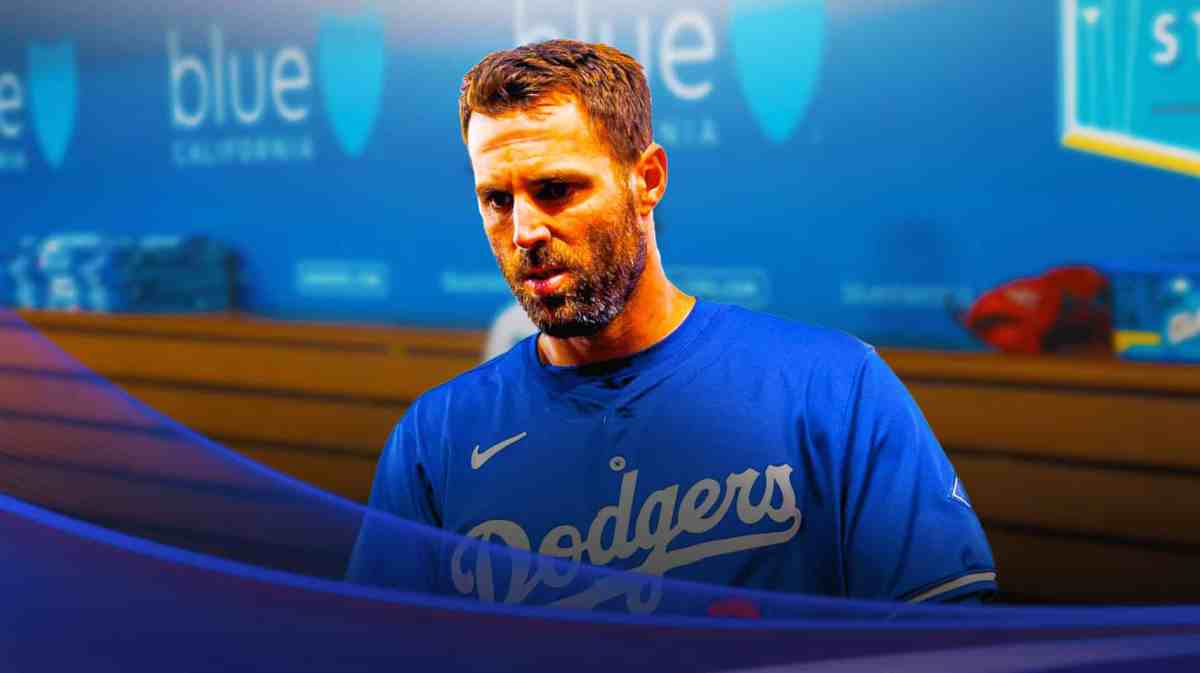 Dodgers' Chris Taylor sitting in an MLB dugout looking upset/serious.