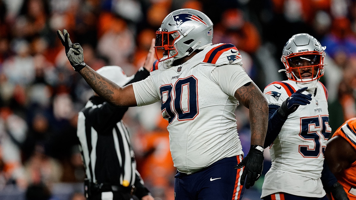 New England Patriots defensive tackle Christian Barmore (90) reacts after a play ]in the third quarter against the Denver Broncos at Empower Field at Mile High.