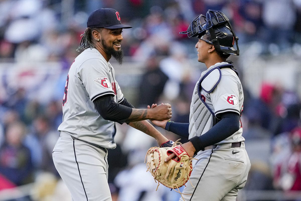 Cleveland Guardians relief pitcher Emmanuel Clase (48) and catcher Bo Naylor (23) react after defeating the Minnesota Twins at Target Field. 