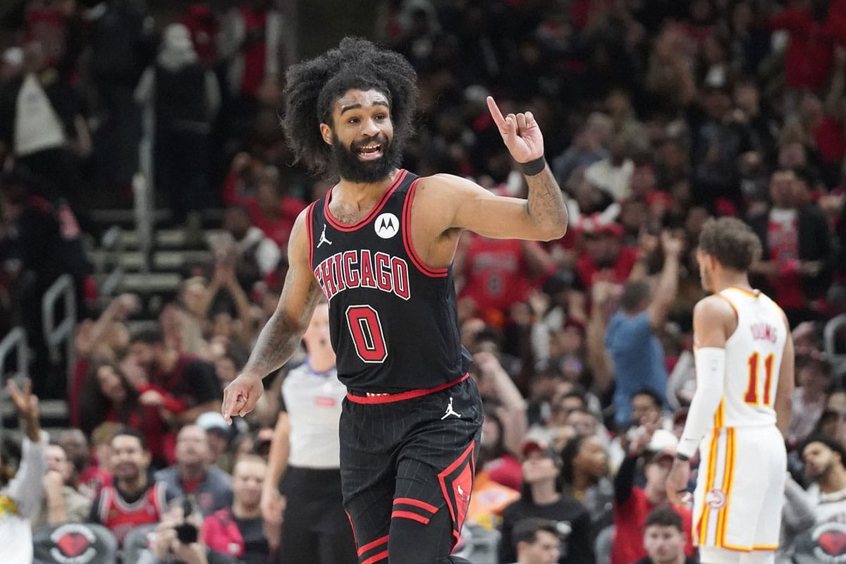 Chicago Bulls guard Coby White (0) gestures after making a three point basket against the Atlanta Hawks during the second half during a play-in game of the 2024 NBA playoffs at United Center.