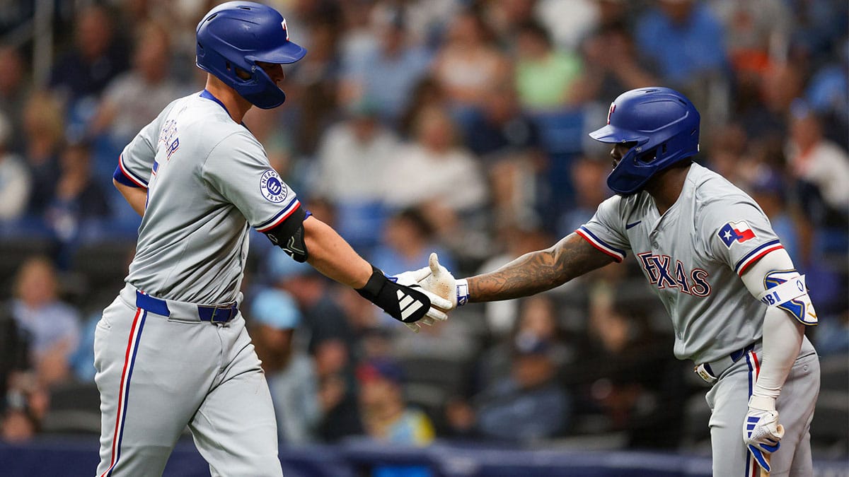 Texas Rangers right fielder Adolis Garcia (53) congratulates designated hitter Corey Seager (5) after hitting a home run against the Tampa Bay Rays in the sixth inning at Tropicana Field.
