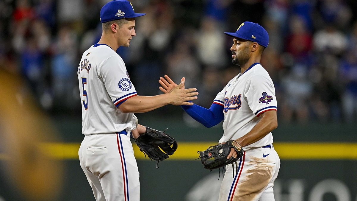 Texas Rangers shortstop Corey Seager (5) and second baseman Marcus Semien (2) celebrate after the Rangers defeat the Oakland Athletics at Globe Life Field.