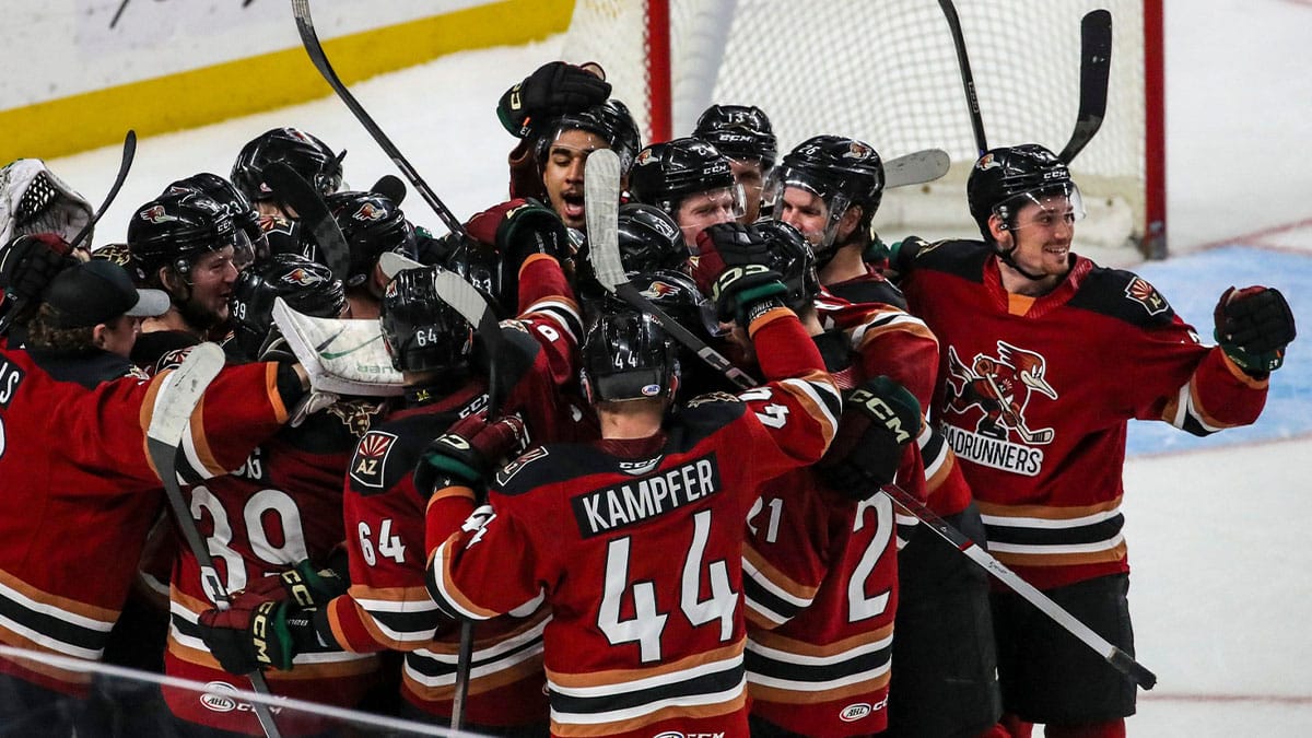 Tucson Roadrunners players celebrate a win after a shootout against the Firebirds at Acrisure Arena in Palm Desert, Calif.