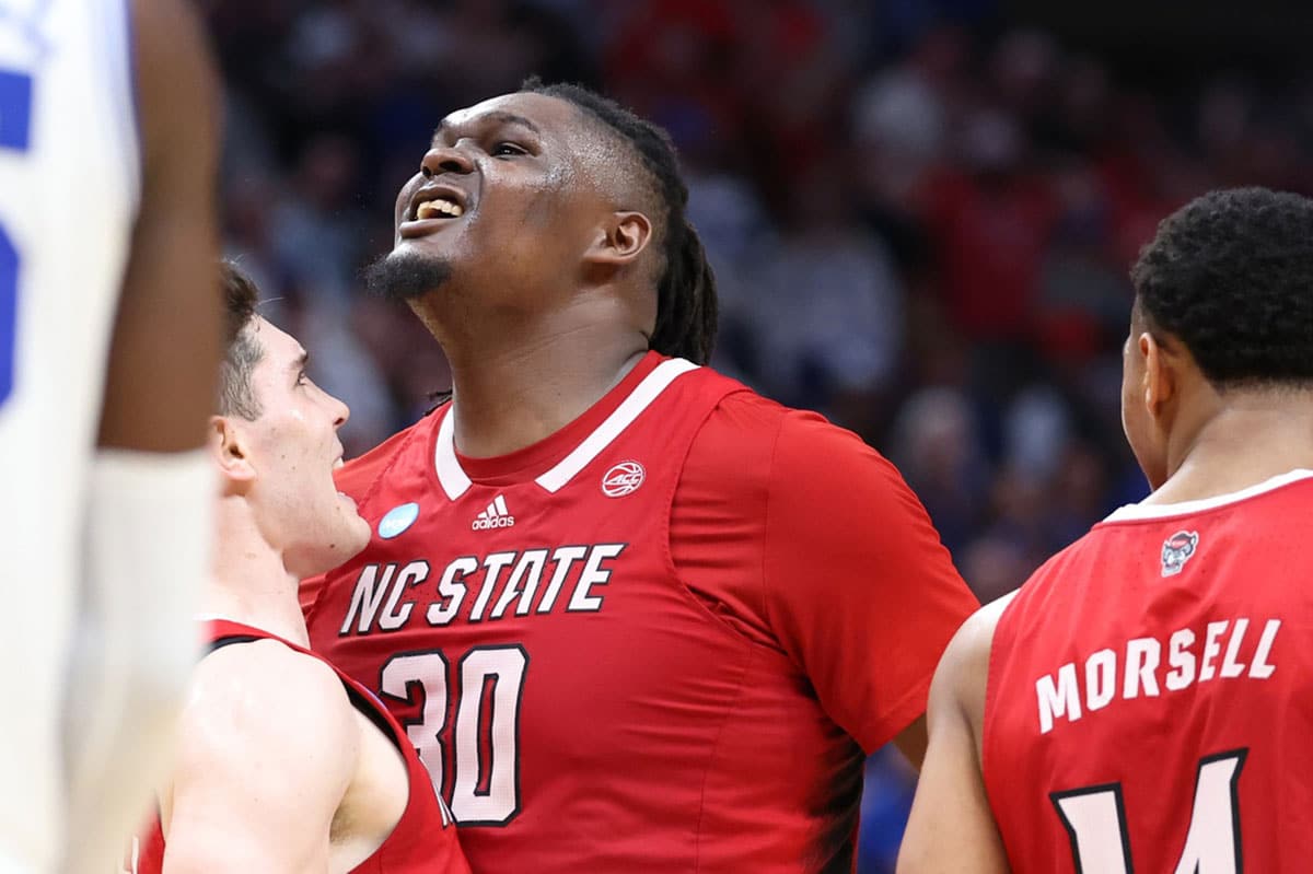 North Carolina State Wolfpack forward DJ Burns Jr. (30) and guard Michael O'Connell (12) celebrate in the second half against the Duke Blue Devils in the finals of the South Regional of the 2024 NCAA Tournament at American Airline Center.