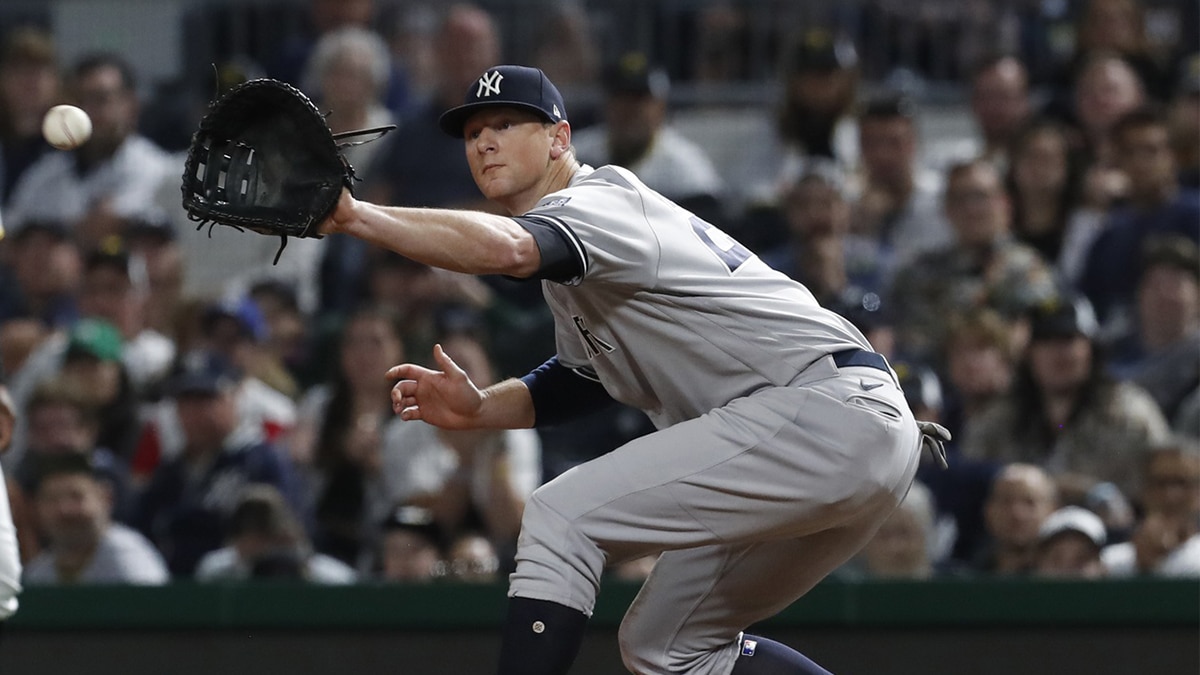 New York Yankees third baseman DJ LeMahieu (26) receives a throw at first base to retire Pittsburgh Pirates third baseman Ke'Bryan Hayes (not pictured) during the ninth inning against at PNC Park. New York won 7-5.
