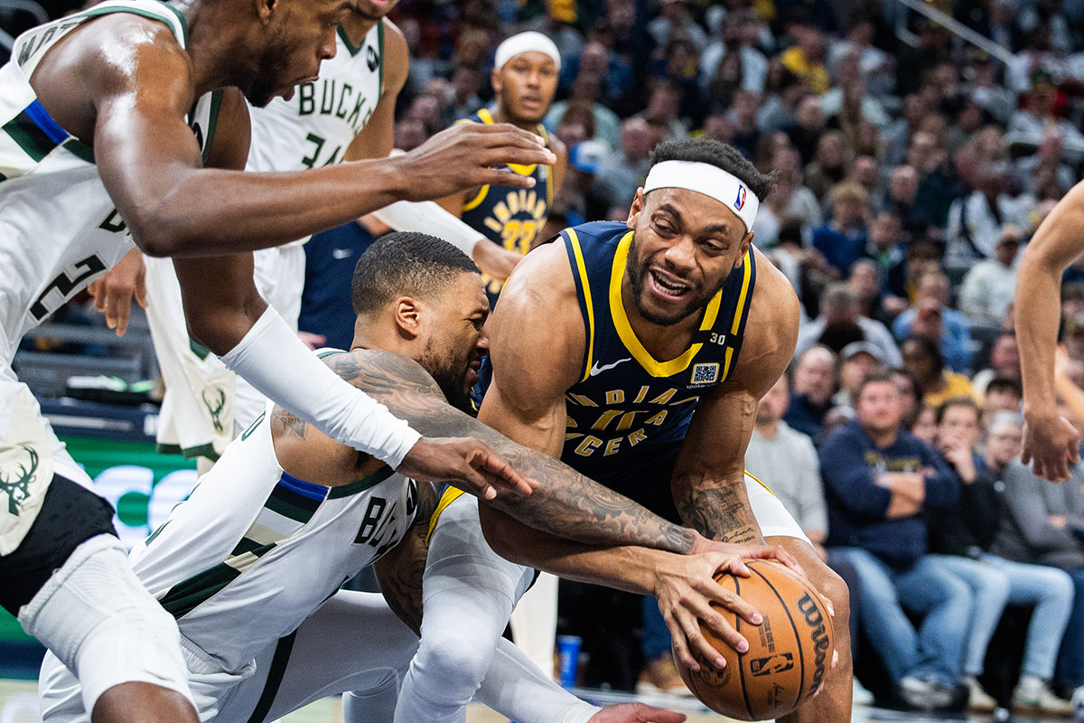 Indiana Pacers forward Bruce Brown (11) and Milwaukee Bucks guard Damian Lillard (0) fight for the ball in the second half at Gainbridge Fieldhouse. 