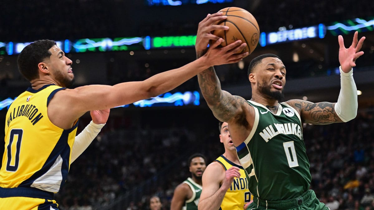 Milwaukee Bucks guard Damian Lillard (0) and Indiana Pacers guard Tyrese Haliburton (0) battle for a rebound in the in the second quarter during game one of the first round for the 2024 NBA playoffs at Fiserv Forum.