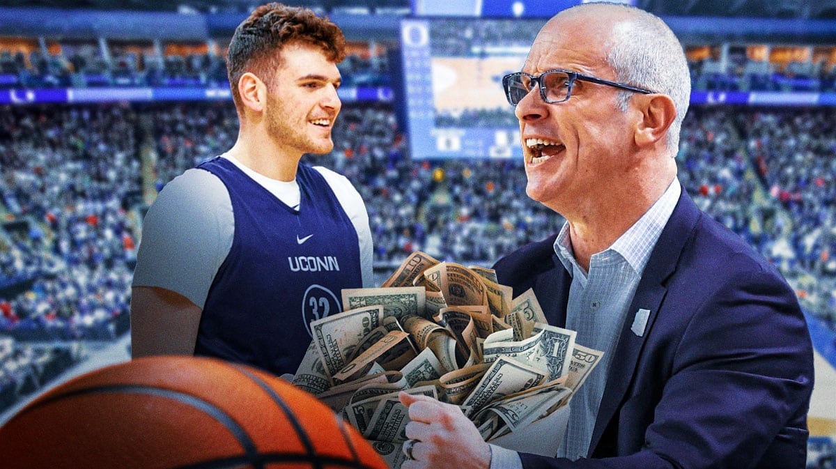 UConn basketball coach Dan Hurley holding lots of money looking at Donovan Clingan.