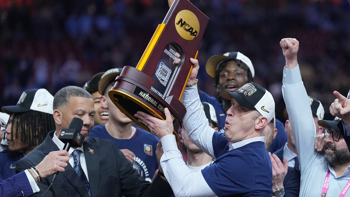 Connecticut Huskies head coach Dan Hurley hoists the championship trophy after defeating the Purdue Boilermakers in the national championship game of the Final Four of the 2024 NCAA Tournament at State Farm Stadium.