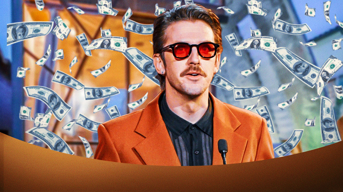 Dan Stevens surrounded by falling cash.