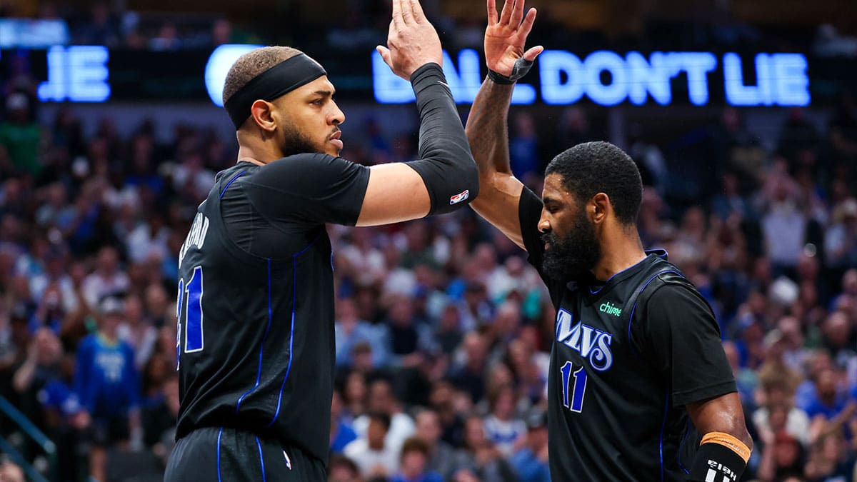 Dallas Mavericks guard Kyrie Irving (11) celebrates with Dallas Mavericks center Daniel Gafford (21) during the second half against the Phoenix Suns at American Airlines Center.