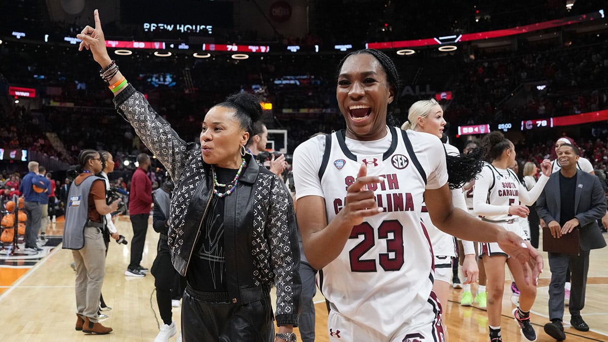 South Carolina Gamecocks head coach Dawn Staley and guard Bree Hall (23) celebrate after defeating the NC State Wolfpack in the semifinals of the Final Four of the womens 2024 NCAA Tournament at Rocket Mortgage FieldHouse.