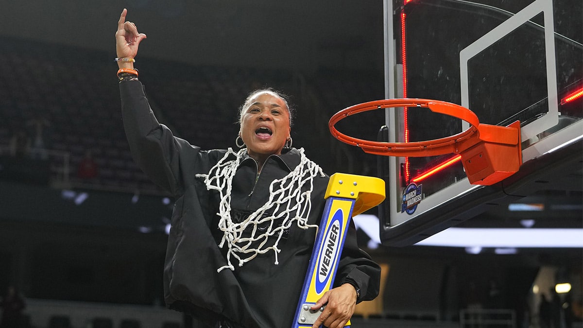 Dawn Staley cutting down the nets for South Carolina after advancing to the Final Four