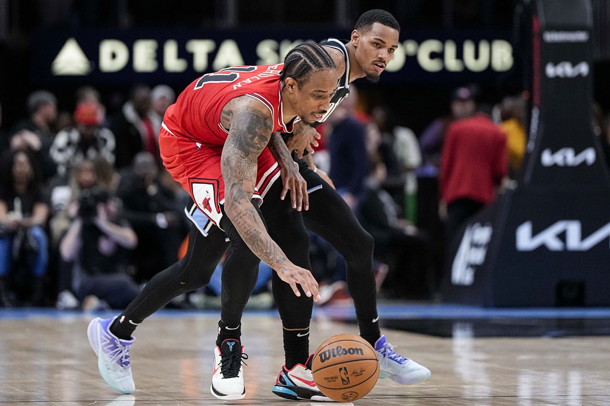 Chicago Bulls forward DeMar DeRozan (11) and Atlanta Hawks guard Dejounte Murray (5) battle for control of the ball during the second half at State Farm Arena.
