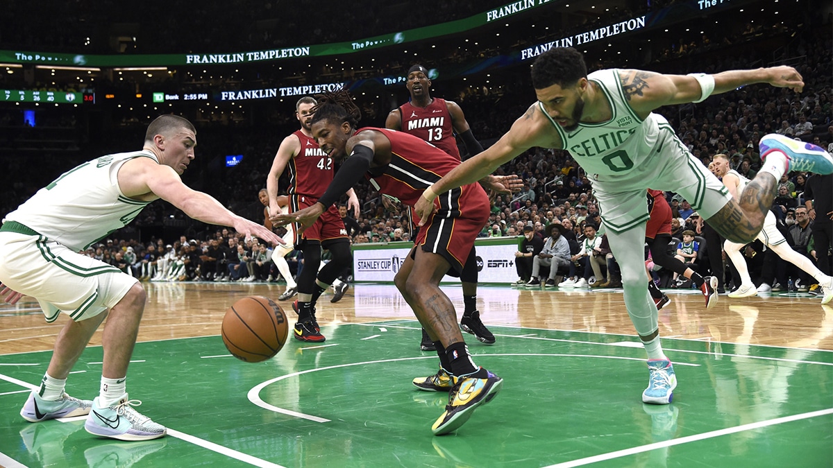Boston Celtics guard Payton Pritchard (11) Miami Heat guard Delon Wright (4) and forward Jayson Tatum (0) battle for a loose ball during the second half in game one of the first round for the 2024 NBA playoffs at TD Garden.