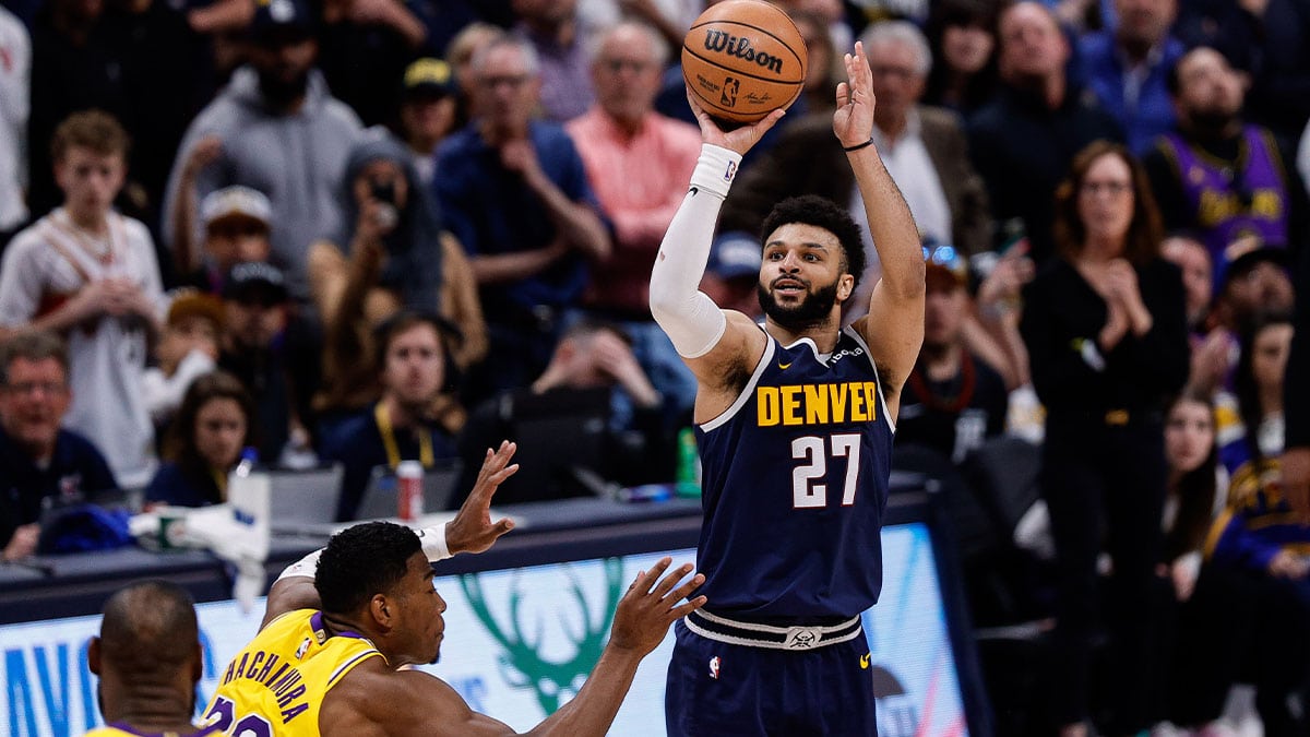 Apr 29, 2024; Denver, Colorado, USA; Denver Nuggets guard Jamal Murray (27) takes a shot against Los Angeles Lakers forward Rui Hachimura (28) in the fourth quarter during game five of the first round for the 2024 NBA playoffs at Ball Arena. Mandatory Credit: Isaiah J. Downing-USA TODAY Sports