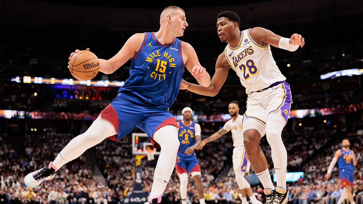 Denver Nuggets player Nikola Jokic guarded by Los Angeles Lakers player Rui Hachimura
