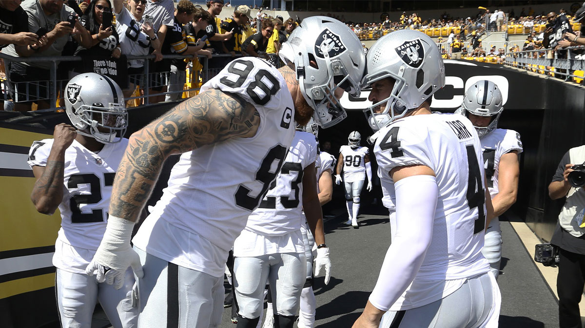 Las Vegas Raiders defensive end Maxx Crosby (98) and quarterback Derek Carr (4) prepare to take the field to play the Pittsburgh Steelers at Heinz Field.
