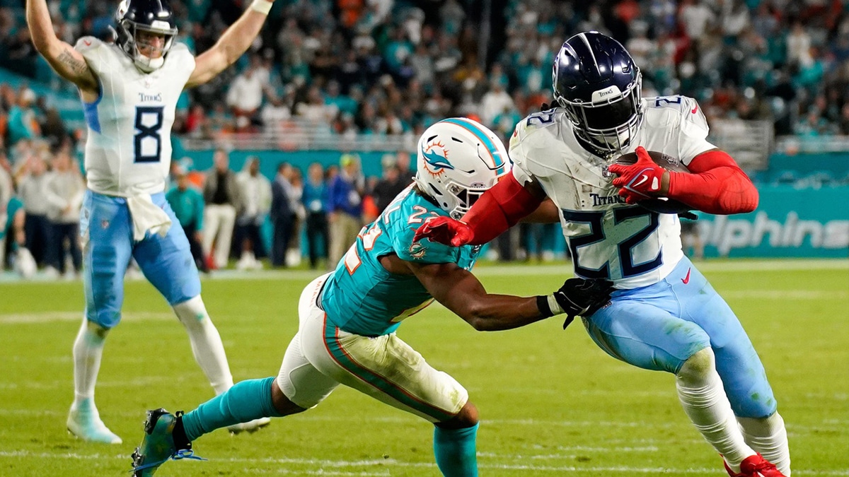Tennessee Titans running back Derrick Henry (22) runs in a touchdown past Miami Dolphins safety Elijah Campbell (22) during the fourth quarter at Hard Rock Stadium in Miami, Fla.,
