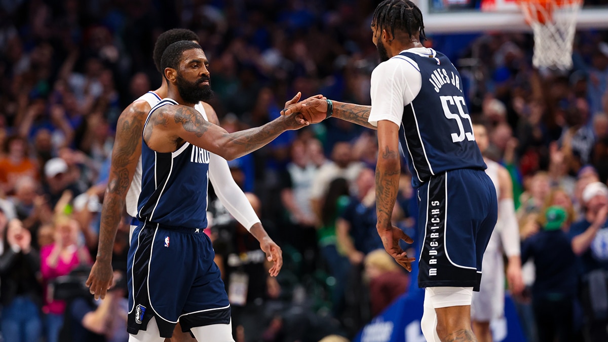 Dallas Mavericks guard Kyrie Irving (11) celebrates with Dallas Mavericks forward Derrick Jones Jr. (55) during the second half against the LA Clippers during game four of the first round for the 2024 NBA playoffs at American Airlines Center. 