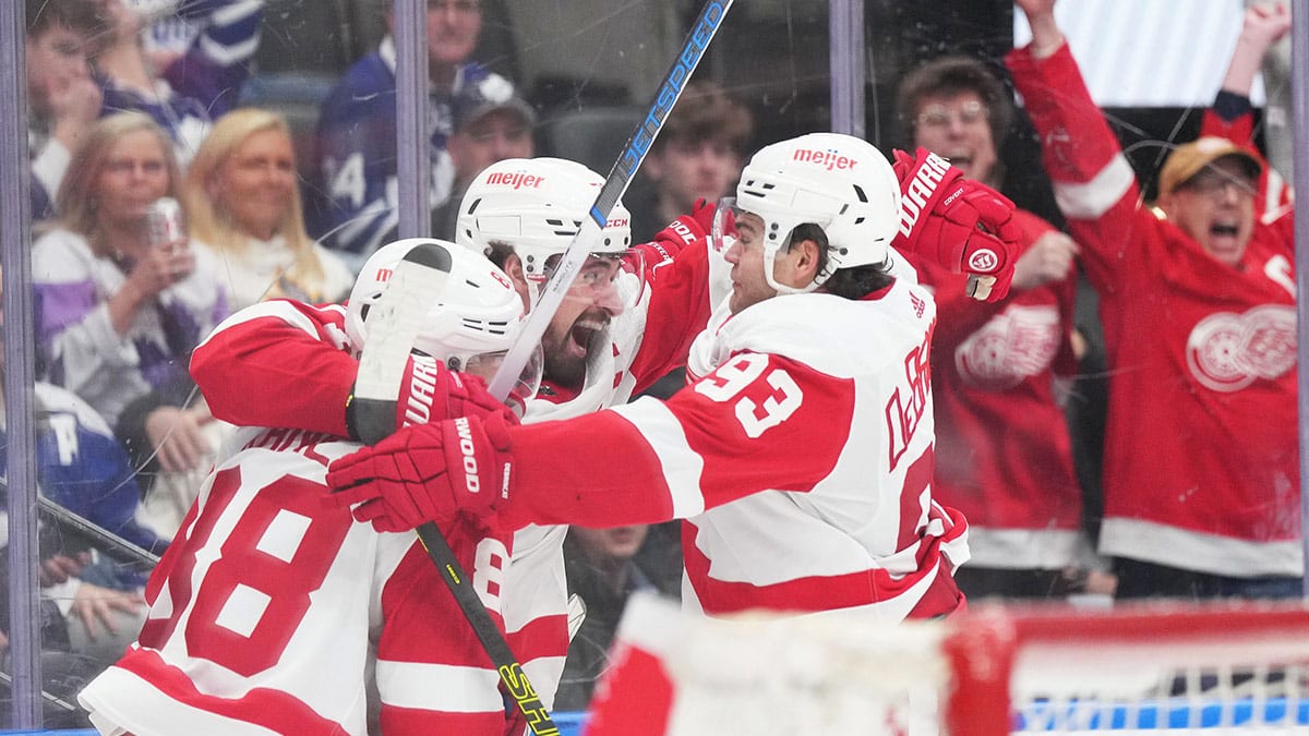 Detroit Red Wings center Dylan Larkin (71) scores the winning goal and celebrates with right wing Alex DeBrincat (93) against the Toronto Maple Leafs during the overtime period at Scotiabank Arena.